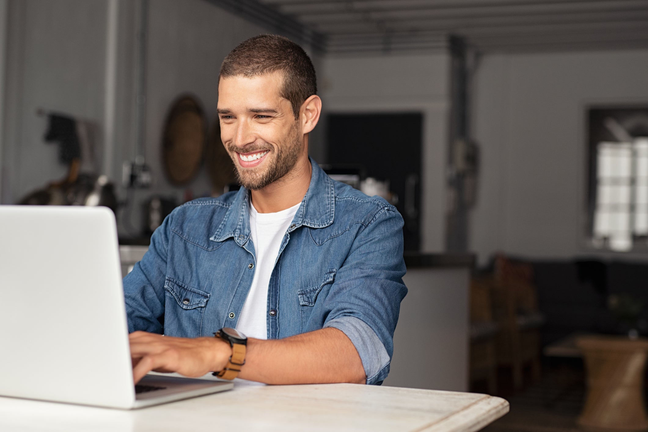Happy man at his desk with laptop